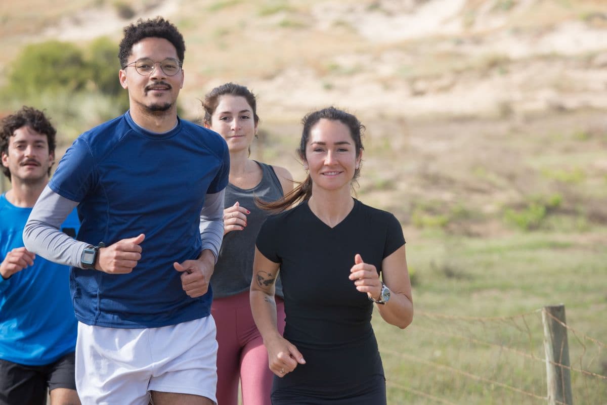 A group of friends running together outdoors